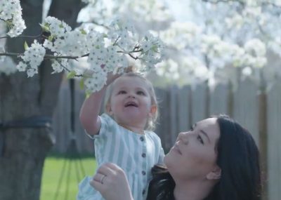 Wife of a lineman with her daughter looking as a blossoming tree.