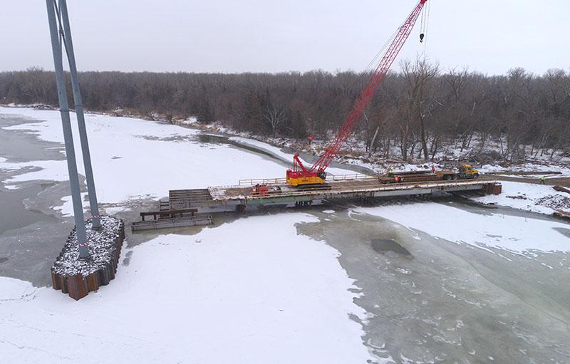 reinforce transmission structures, A temporary structures goes out into the Platte River so workers can reinforce the towers.