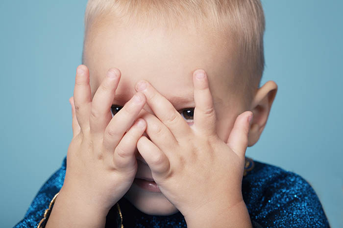 boy covering his eyes in fear. helping children cope with storms